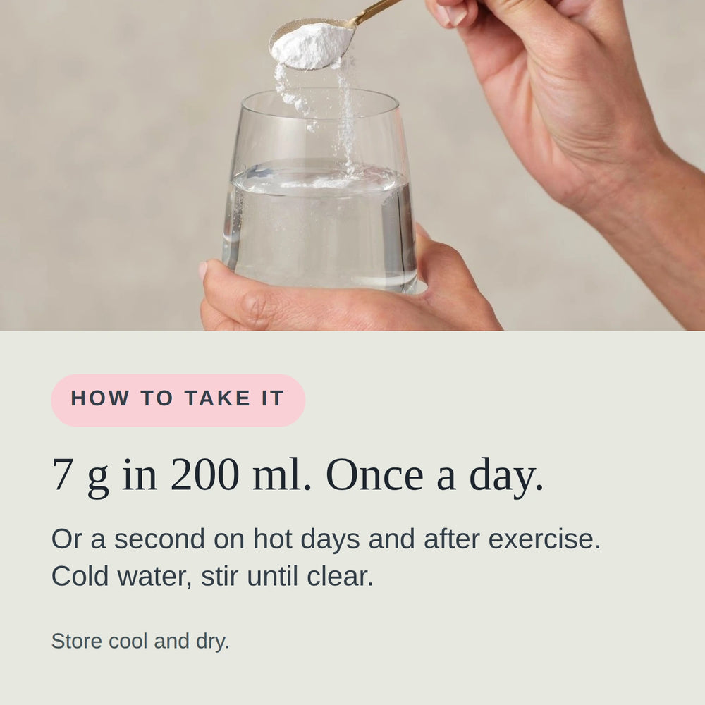 One 7 g scoop of Hydrate + Replenish being stirred into a glass of water.