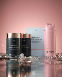 Two bottles of MyPause Hydrate + Replenish beside a pink MyPause steel shaker bottle, with water splashing against a pink background.