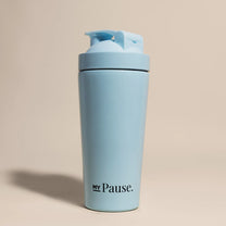The MyPause steel shaker bottle in light blue, with a matching flip-top lid, on a beige background.