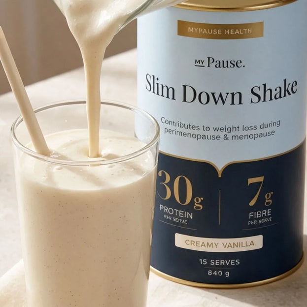 A thick creamy vanilla Slim Down Shake being poured into a glass, beside the 840g Creamy Vanilla tin showing 30g protein and 7g fibre per serve.